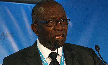 Jack_Warner_grimacing_behind_lectern