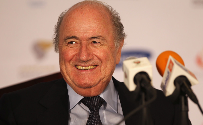 Sepp_Blatter_smiling_behind_microphone