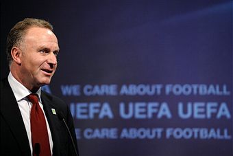 Karl-Heinz_Rummenigge_in_front_of_UEFA_logo