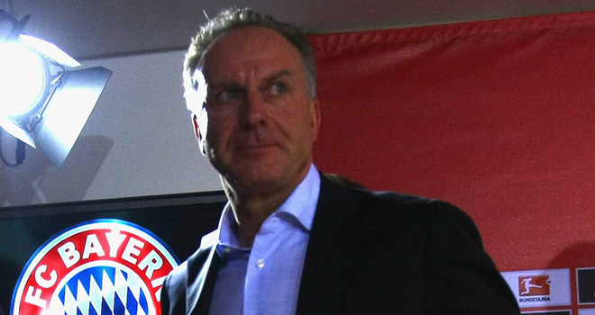 Karl Heinz_Rummenigge_in_front_of_Bayern_Munich_logo