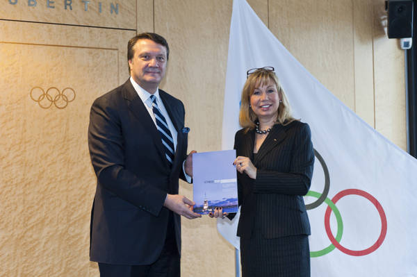 Hasan Arat_with_Jacquelin_Barrett_handing_over_bid_book_February_2012