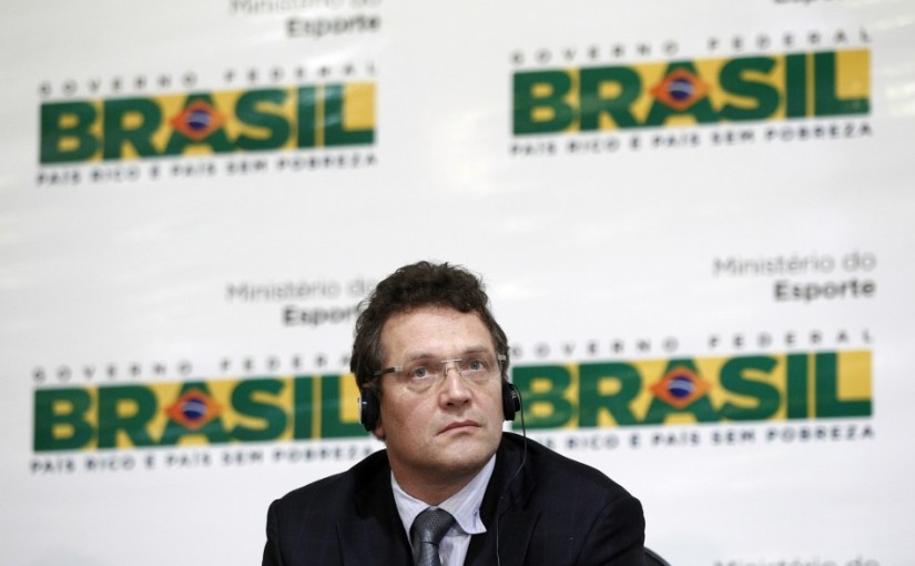 Jerome Valcke_in_front_of_Brazil_2014_logo