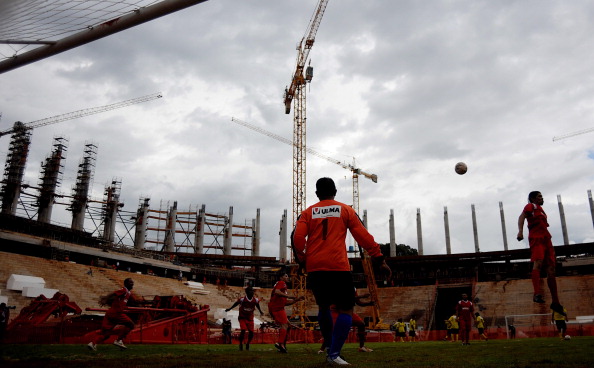 Workers of the new National Stadium Brazil try out a game of football on the improvised field back in March 2012