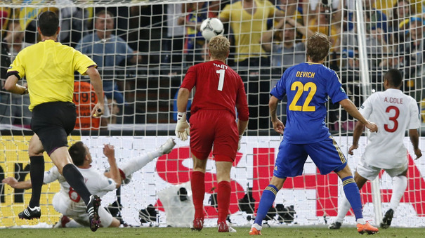 127804--ukraines-marko-devic-watches-as-his-goal-bound-shot-is-cleared-by-john-terry-replays-showed