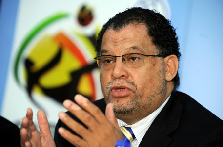 Danny Jordaan_in_front_of_South_Africa_2010_logl