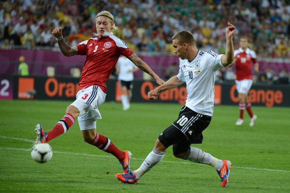 German forward_Lukas_Podolski_R_vies_with_Danish_defender_Simon_Kjr_26-06-12