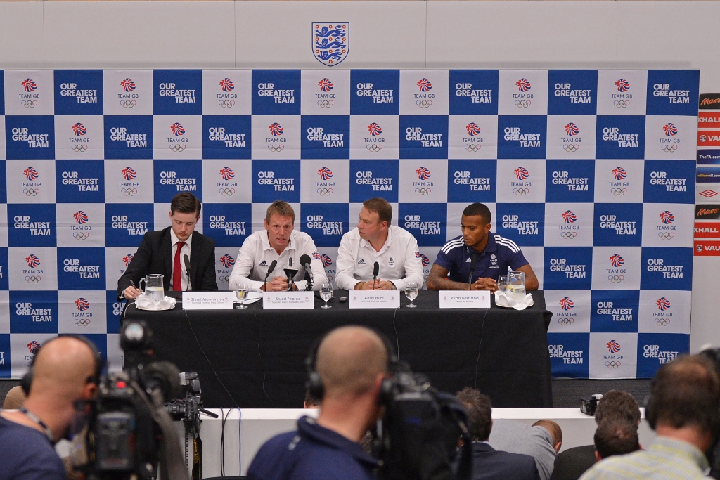 Stuart Mawhinney_Facing_L_Team_GB_football_press_officer_Stuart_Pearce_Facing_2nd_L_British_Olympic_football_coach_Andy_Hunt_Facing_2nd_R_Team_GB_Chef_de_Mission_and_Ryan_Bertrand_02-07-12