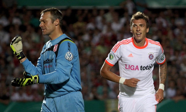 Michael Hofmann_L_of_Jahn_Regensburg_reacts_as_Mario_Mandzukic_of_Bayern_Muenchen_21-08-12